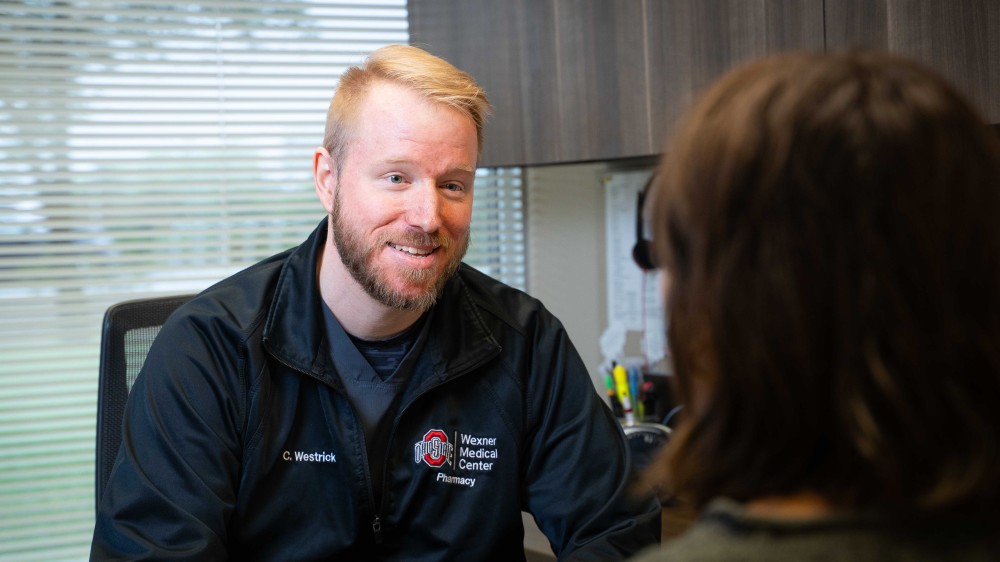 pharmacist talking with patient in office
